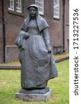 Small photo of Statue of a Beguine in the courtyard of The Begijnhof, Amsterdam, the Netherlands. 27th June 2014