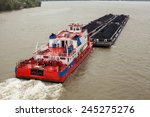 Top View Of Tugboat Pushing A...