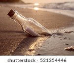Message in the bottle washed ashore against the Sun setting down