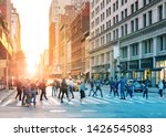 Crowds of people in motion across the busy intersection of 23rd Street and 5th Avenue in Midtown Manhattan, New York City NYC