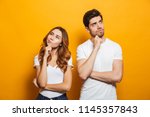 Image of happy young people man and woman in basic clothing thinking and touching chin while looking aside isolated over yellow background