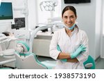 Small photo of European mid dentist woman smiling while standing in dental clinic