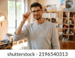 Small photo of White bristle man in eyeglasses smiling while working at office indoors