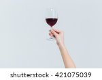 Female hand holding glass with wine isolated on a white background