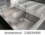 Angle view of kitchen sink with silver faucet