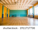 Small photo of Modern new school building. Empty school gymnasium with yellow floor and climbing near walls