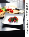 Small photo of Broccoli tomato salad with pepper, compositions with tuple and wooden board
