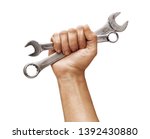 Man's hand holds a spanners...
