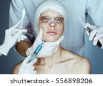 Patient in bandages. Nurses holding scalpel and syringe near her face. Plastic Surgery concept