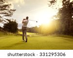 Man playing golf on a golf course in the sun