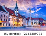 Small photo of Maribor, Slovenia. Twilight colored Main Square with Plague Column, slovene travel spotlight.