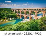 Small photo of Pont du Gard, France. Ancient three-tiered aqueduct, built in Roman Empire times on the river Gardon. Provence, tourist destination, summer sunny day landscape.