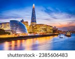 Small photo of London, United Kingdom. Skyline view of the famous New London, City Hall and Shard, golden sunset hour. View includes Thames River, skyscrapers, office buildings and beautiful sky.