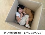 A Little Girl Hide In Cardboard ...