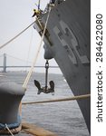 Small photo of STATEN ISLAND, NY - MAY 20 2015: Linesmen work on the bow of USS Barry (DDG 52) guided-missile destroyer mooring for Fleet Week NY at Sullivans Pier with the Verrazano-Narrows Bridge in background.
