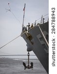 Small photo of STATEN ISLAND, NY - MAY 20 2015: Linesmen work on the bow of USS Barry (DDG 52) guided-missile destroyer mooring for Fleet Week NY at Sullivans Pier with the Verrazano-Narrows Bridge in background.