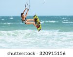 A Kite Surfer Rides The Waves.