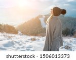 Portrait Happy woman traveler on the top of mountain and looking on beautiful winter snowy view.