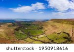 Aerial view of rural farmland and hills in Wales (Hay Bluff on the Welsh-English Border)