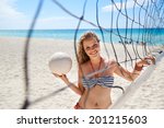 Portrait of young beautiful girl vacationing in Varadero, Cuba, playing beach volley near the sea