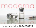 Small photo of Milan, Italy: November 14, 2020: Vials and syringe with Moderna Inc logo. Big Pharma companies are completing clinical trials to get the approval for a vaccine to fight the coronavirus Covid-19 virus