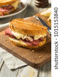 Small photo of Savory Homemade Corned Beef Reuben Sandwich with Mustard and Cheese