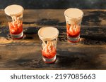 Small photo of Boozy Halloween Brain Hemorrhage Shot Cocktail with Peach and Grenadine