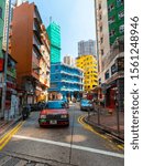 Small photo of Hong Kong - October 4, 2019: Taxi in front of colorful building in Stone Nullah Ln, Wan Chai.