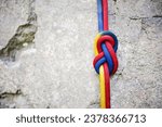 Small photo of eight climbing knot with colorful rope on rocky background