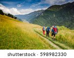 Hikers Walking In The Mountains....
