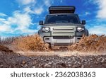 Small photo of Off road tourist car rides off-road in the highlands. Expedition travel and vacation, adventures in remote areas.