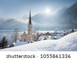 Panoramic view of famous Hallstatt lakeside town during winter sunrise on a beautiful cold sunny day at Christmas time, Salzkammergut, Austria