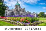 Beautiful view of historic parliament building in the citycenter of Victoria with colorful flowers on a sunny day, Vancouver Island, British Columbia, Canada