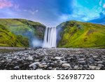 Classic long exposure view of famous Skogafoss waterfall in beautiful twilight during blue hour at dusk in summer, Skogar, south of Iceland