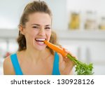 Happy Young Woman Eating Carrot ...