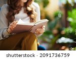 Green Home. Closeup on female with long wavy hair with book in the house in sunny day.