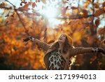 Hello november. smiling trendy 40 years old woman in beige coat and orange hat rejoicing outside in the city park in autumn.