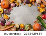 autumn flat lay on a concrete background with pumpkins, beetroot, autumn leaves, autumn leaf and autumn vegetables.