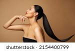 Small photo of Beauty Model Profile. Young Woman with long Ponytail Hair. Women Face Side view over beige background. Lady with Red Lipstick and Black Straight Tail Hairstyle