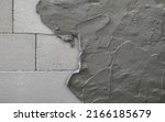 Small photo of Cement mortar mixed to bond building blocks and coating lightweight concrete wall surface. Plaster texture layer. Building construction.