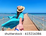 Traveling together. Follow me. Young woman in straw hat holding boyfriend's hand walking on the pier