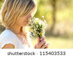 Young Woman Smelling Flowers In ...