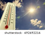 Heat, thermometer shows the temperature is hot in the sky, summer