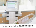 Small photo of Fetal monitor with Printing of cardiogram by Electrocardiograph. Graph recording of cardiogram from Electronic fetal monitor use for heartbeat examination. Pregnancy care technology concept.