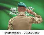 Dark-skinned soldier in hat facing national flag series - Saudi Arabia