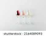 Flat-lay of red, rose and white wine in glasses on white background. Wine bar, winery, wine degustation concept. Minimalistic trendy photography