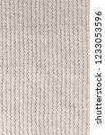 white knitted fabric close up.... | Shutterstock . vector #1233053596
