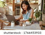 Online Job. Girl With Laptop At Cafe. Business Woman In Jeans Outfit Working At Coffee Shop Portrait. Digital Nomad Lifestyle For Remote Working Or Studying On Summer Vacation. 