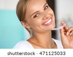 White Teeth. Closeup Portrait Of Beautiful Happy Woman With Perfect White Smile Using Teeth Whitening Tray. Smiling Girl Holding Medical Invisible Braces. Dental Health Concept. High Resolution Image