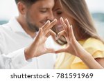 Beautiful Couple In Love Making Heart With Hands. Happy Smiling Young People Hugging, Showing Heart Shape With Hands And Enjoying Each Other Outdoors. Romantic Relationships. High Quality Image.